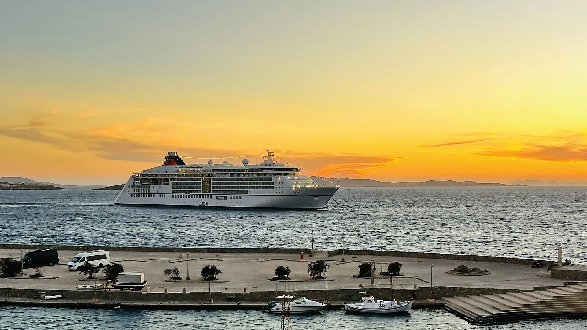 Cruise ship off the Old Port of Mykonos at sunset