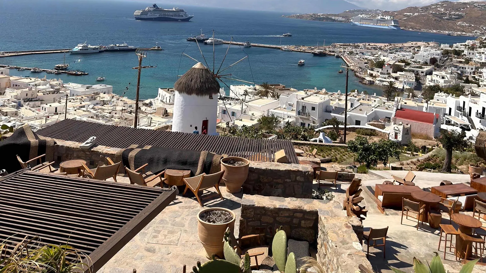Mykonos Town, its windmill and the sea seen from a terrace above the old port