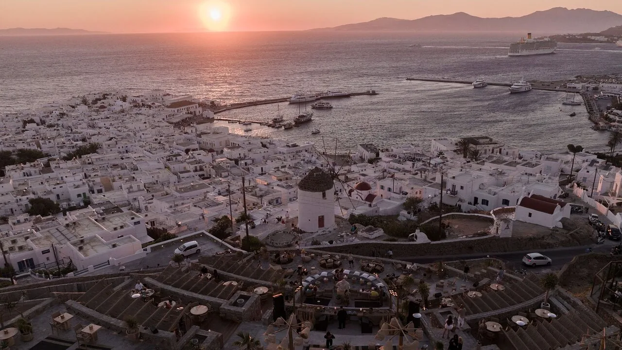 Sunset over Mykonos Town and the sea, seen from the hillside